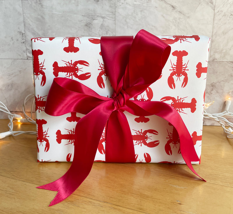 Red lobsters printed on a cream background on wrapping paper