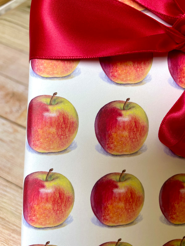 Realistic red apples printed on a cream background on wrapping paper